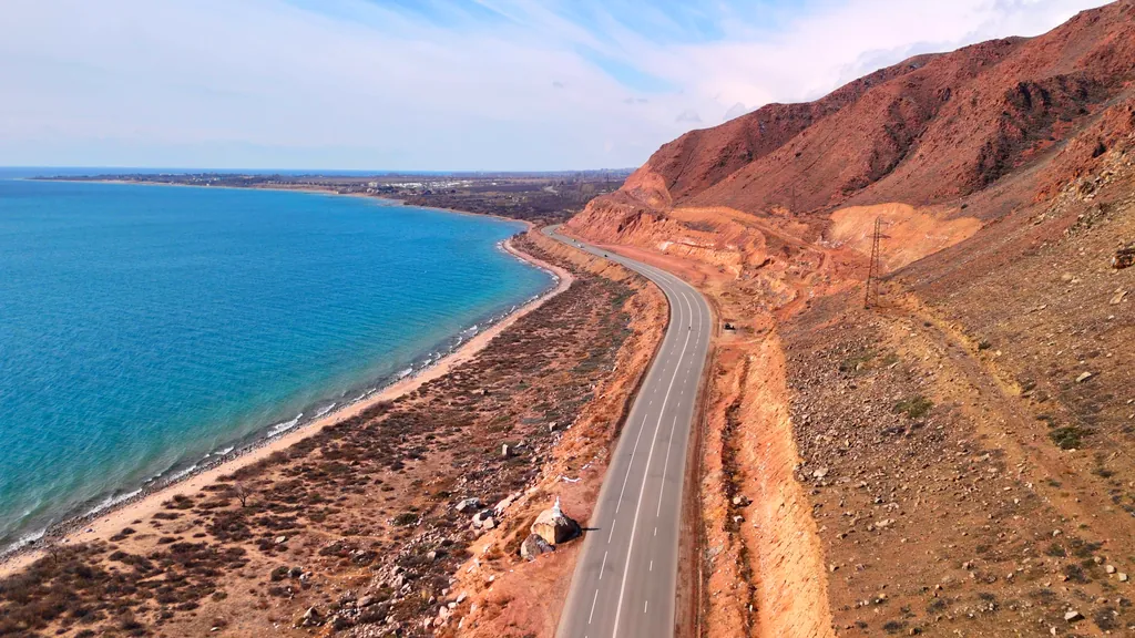 The road along Lake Issyk-Kul passing next to the mountains