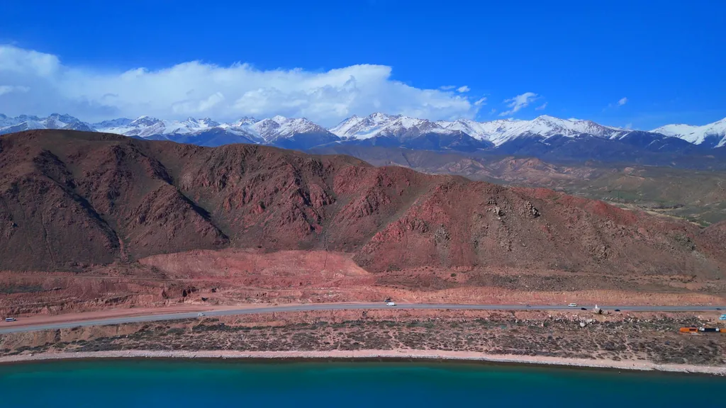 View from Lake Issyk-Kul to the road and mountain peaks