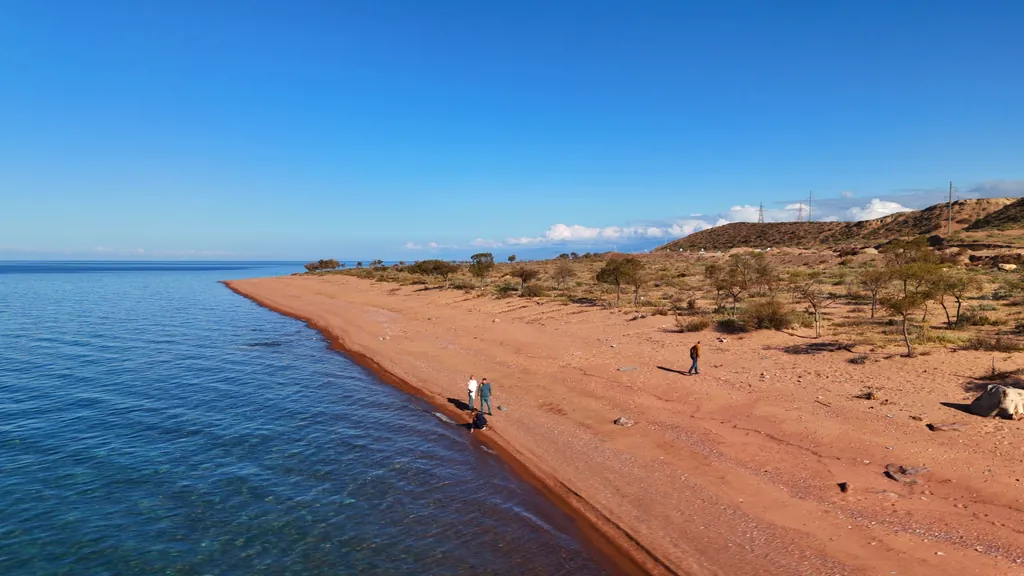 Tourists on the southern shore of Lake Issyk-Kul in spring