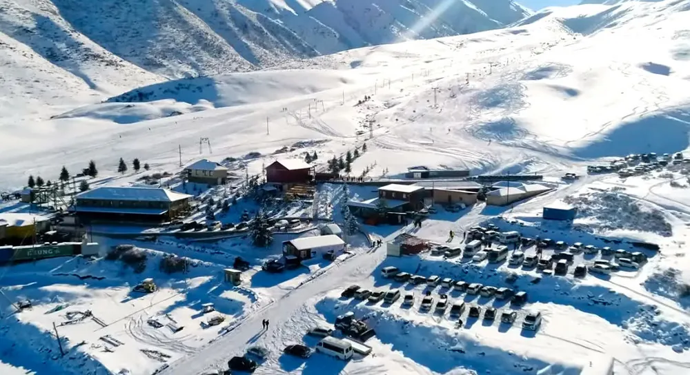 View of the entrance, lifts, and parking lot at ZIL ski base in Kyrgyzstan